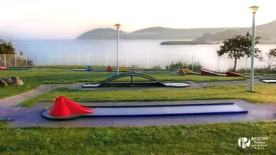 a park with a bunch of play equipment in the grass at Apartamentos Las Sirenas in Viveiro