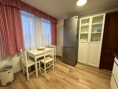 a kitchen with a table and chairs and a refrigerator at Casa Da Ponte By Oktheway in Puentedeume