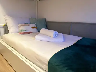 a bed with two towels and pillows on it at Casa Da Ponte By Oktheway in Puentedeume