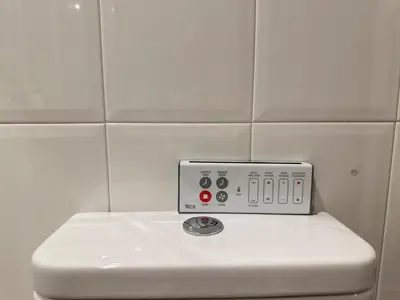 a white tiled wall with a stove in a bathroom at Casa Da Ponte By Oktheway in Puentedeume
