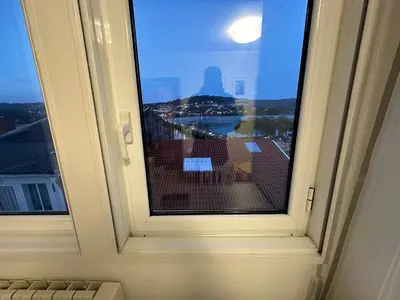 a window with a view of a city at Casa Da Ponte By Oktheway in Puentedeume