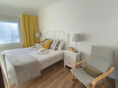 a bedroom with a bed and a chair and a window at Casa Da Ponte By Oktheway in Puentedeume