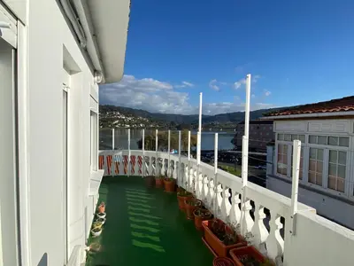 a view from the balcony of a building with green water at Casa Da Ponte By Oktheway in Puentedeume