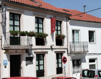 a white building with windows and balconies on a street at San Clemente by Pousadas de Compostela in Santiago de Compostela