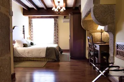 a bedroom with a bed and a window at Airas Nunes by Pousadas de Compostela in Santiago de Compostela