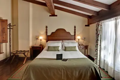 a bedroom with a large bed in a room at Airas Nunes by Pousadas de Compostela in Santiago de Compostela