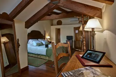a bedroom with a bed and a table in a room at Airas Nunes by Pousadas de Compostela in Santiago de Compostela