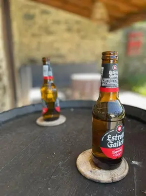 two bottles of beer sitting on top of a table at A Costa, Valle del Mendo in Oza dos Ríos