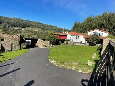 a road leading to a tunnel in a village at A Costa, Valle del Mendo in Oza dos Ríos
