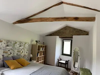 a bedroom with a white bed and a window at A Costa, Valle del Mendo in Oza dos Ríos