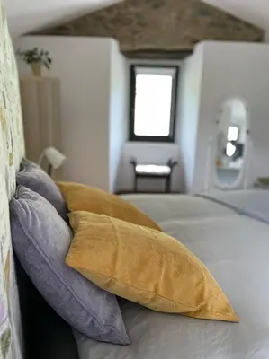 a bedroom with a bed with two pillows on it at A Costa, Valle del Mendo in Oza dos Ríos