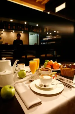 a table with food and drinks on a table at Hotel Altaïr in Santiago de Compostela