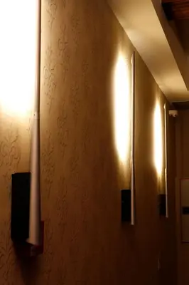a hallway with two lights on a wall at Hotel Altaïr in Santiago de Compostela