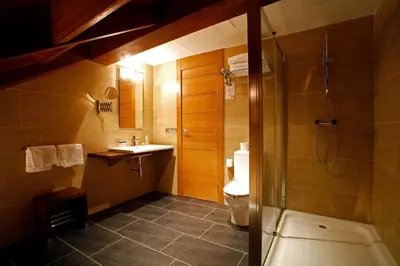 a bathroom with a toilet and a sink and a shower at Hotel Altaïr in Santiago de Compostela