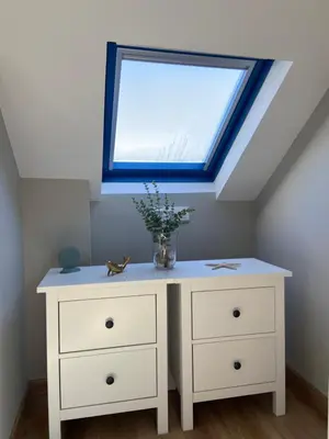 a white dresser with a window in a attic at O Faiado by Oktheway in Puentedeume