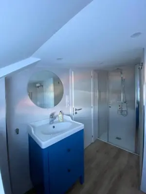 a bathroom with a sink and a mirror and a shower at O Faiado by Oktheway in Puentedeume