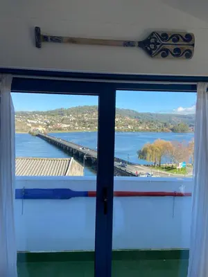 a window with a view of a pier and water at O Faiado by Oktheway in Puentedeume