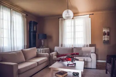 a living room with couches and a coffee table at Houmi A Ponte in Boimorto
