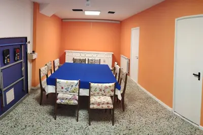 a dining room with a blue table and chairs at Casa Carmiña: Casa para pequeños grupos en el corazón de Galicia in O Irixo