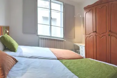 a bedroom with a bed and a large window at Casa Carmiña: Casa para pequeños grupos en el corazón de Galicia in O Irixo