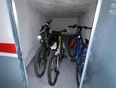 three bikes are parked in a garage at Estudio céntrico 2 con terraza y parking privado in Ourense