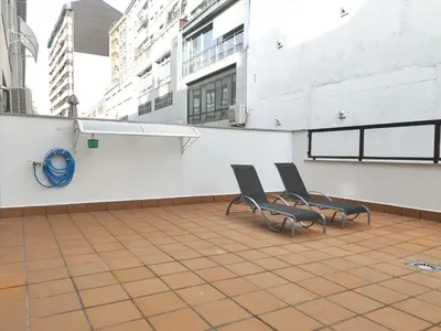 two chairs sitting on the roof of a building at Estudio céntrico 2 con terraza y parking privado in Ourense