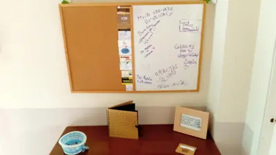 a room with a whiteboard with writing on the wall at A parada da Ribeira in Ourense