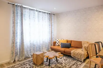 a living room with a couch and a table at Zafiro Flat by Serendipia Turismo in Santiago de Compostela