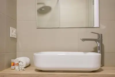 a white sink in a bathroom with a mirror at Zafiro Flat by Serendipia Turismo in Santiago de Compostela