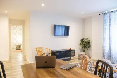 a dining room with a table with a laptop on it at Zafiro Flat by Serendipia Turismo in Santiago de Compostela