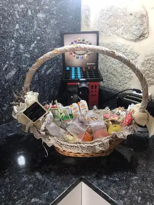 a basket of food on a counter next to a laptop at Casa Escuela Trasmiras, Casa dos Mestres in Trasmiras