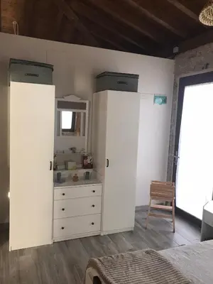 a bedroom with two white cabinets and a dresser at Casa Escuela Trasmiras, Casa dos Mestres in Trasmiras