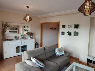 a living room with a couch and a kitchen at Piso Prol in Ourense