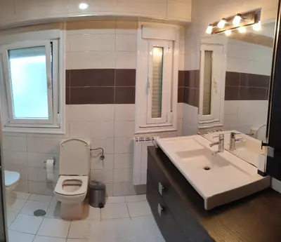 a bathroom with a toilet and a sink at Piso Prol in Ourense