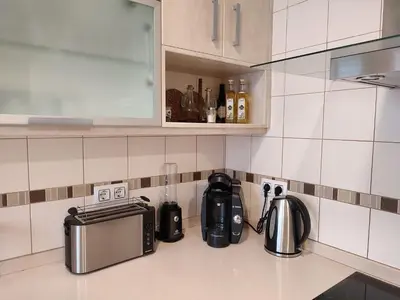 a kitchen counter with a coffee maker and a toaster at Piso Prol in Ourense