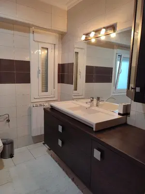 a bathroom with a large sink and a large mirror at Piso Prol in Ourense