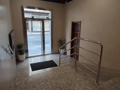 a stairway with a metal handrail and a door with a window at Piso Prol in Ourense