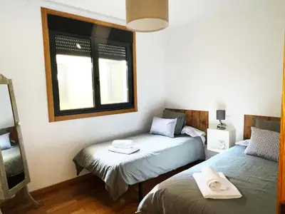 a bedroom with two beds and a window at Ático Alquiler Mondaríz Paraiso del agua. Vistas espectaculares in Mondariz