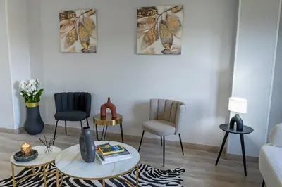 a living room with two chairs and a table at Hotel Faranda Los Tilos, Ascend Hotel Collection in Teo