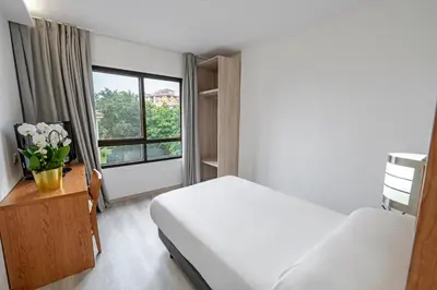 a hotel room with a bed and a window at Hotel Faranda Los Tilos, Ascend Hotel Collection in Teo