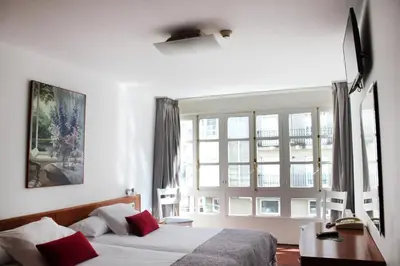 a bedroom with a bed and a large window at Hotel Hórreo by Bossh! Hotels in Santiago de Compostela