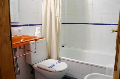 a bathroom with a toilet and a bath tub at Hotel Hórreo by Bossh! Hotels in Santiago de Compostela