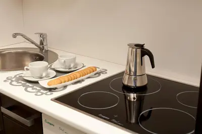 a small kitchen with a sink and a microwave at Aparthotel Attica21 As Galeras in Bastiagueiro