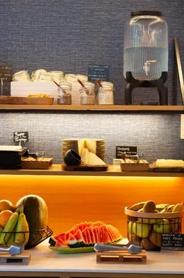 a display shelf with fruits and vegetables in baskets at Hotel Universal in Santiago de Compostela