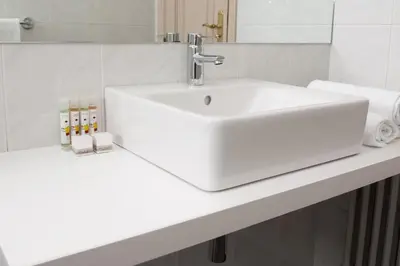 a bathroom with a sink and a white counter at Hotel Universal in Santiago de Compostela