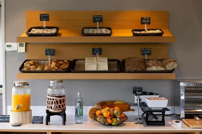 a shelf with baskets of bread and a bowl of fruit at Hotel Santiago Apóstol in Santiago de Compostela