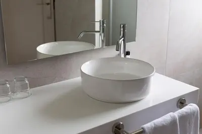 a white bathroom with a sink and a mirror at Hotel Santiago Apóstol in Santiago de Compostela