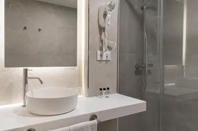 a bathroom with a sink and a shower at Hotel Santiago Apóstol in Santiago de Compostela
