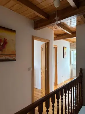a staircase in a house with wooden ceilings at Casa De Don Lino in Lugo