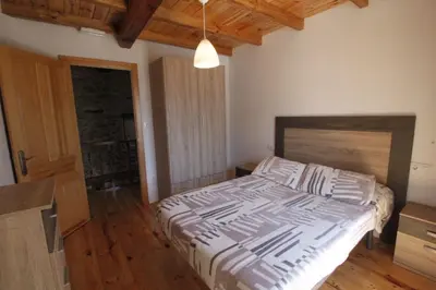a bedroom with a large bed with a wooden floor at Casa De Don Lino in Lugo